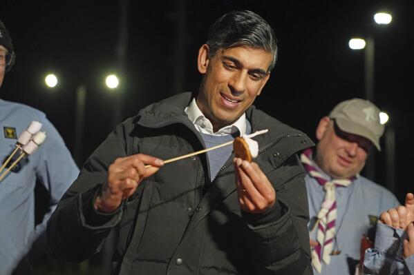 Britain's Prime Minister Rishi Sunak toasts marshmallows during a visit to the Sea scouts community group in Muirtown near Inverness, Scotland, Thursday Jan. 12, 2023. (Andrew Milligan/Pool via AP)