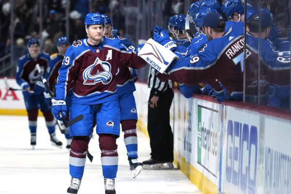 Colorado Avalanche center Nathan MacKinnon (29) is congratulated for a goal against the Nashville Predators during the first period in Game 1 of an NHL hockey Stanley Cup first-round playoff series Tuesday, May 3, 2022, in Denver. (AP Photo/Jack Dempsey)