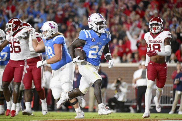 Mississippi running back Ulysses Bentley IV (24) makes a 7-yard touchdown run during the second half of an NCAA college football game against Arkansas in Oxford, Miss., Saturday, Oct. 7, 2023. \(AP Photo/Thomas Graning)