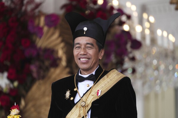 FILE - Indonesian President Joko Widodo, dressed in traditional Central Javanese royalty outfit, smiles during a ceremony marking the country's 78th anniversary of independence at Merdeka Palace in Jakarta, Indonesia, on Aug. 17, 2023. Widodo’s phenomenal rise from a riverside slum, where he grew up, to the presidency of Indonesia spotlighted how far the world’s third-largest democracy had veered from a brutal authoritarian era decades ago. With his second and final five-year term ending in October, Widodo, regarded by some as Asia's Barack Obama, is leaving a legacy of impressive economic growth and an ambitious array of infrastructure projects including a $33 billion plan to relocate Indonesia's congested capital to the frontier island of Borneo. (AP Photo/Achmad Ibrahim, File)