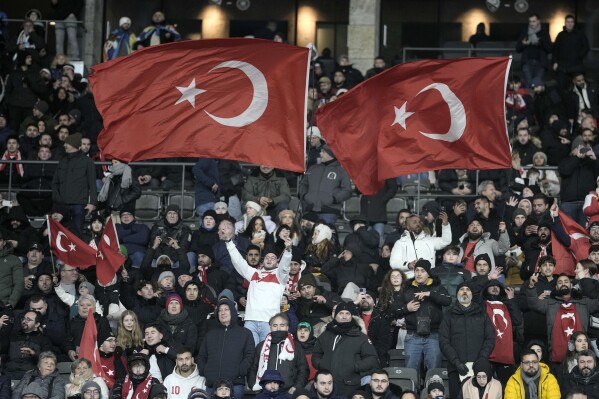 Turkey supporters wave flags prior the international friendly soccer match between Germany and Turkey in Berlin, Germany, Saturday, Nov. 18, 2023. (AP Photo/Markus Schreiber)
