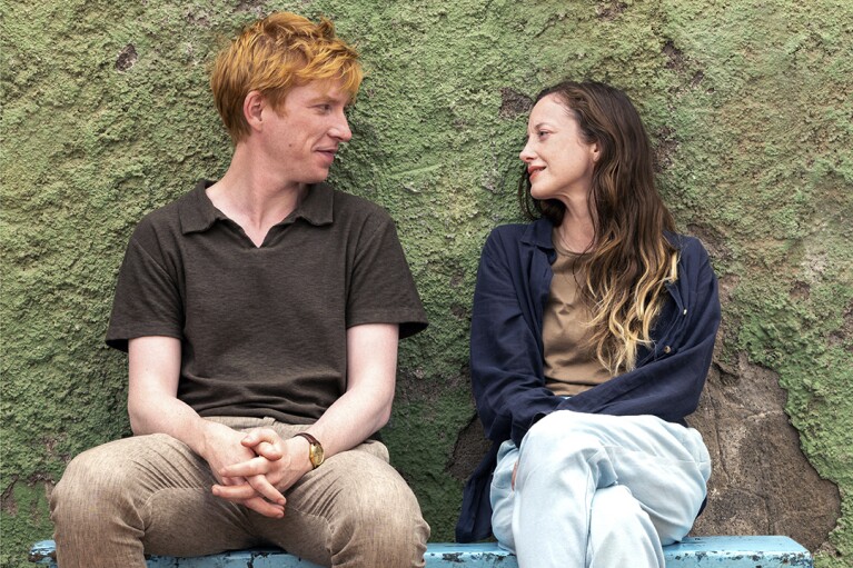 This image released by PBS shows Domhnall Gleeson, left, and Andrea Riseborough in a scene from MASTERPIECE "Alice & Jack," premiering Sunday March 17 on PBS. (Fremantle/PBS via AP)
