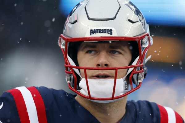 FILE - New England Patriots quarterback Mac Jones prior to an NFL football game against the New York Jets, Jan. 7, 2024, in Foxborough, Mass. A person familiar with negotiations says the Jacksonville Jaguars have agreed to acquire Mac Jones in exchange for a late-round pick in next month's NFL draft. The person spoke to The Associated Press on condition of anonymity Sunday, March 10, 2024 because the trade cannot become official until the new league year begins Wednesday and after Jones passes a physical. (AP Photo/Michael Dwyer)