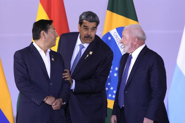 Bolivia's President Luis Arce, from left, Venezuela's President Nicolas Maduro and Brazilian President Luiz Inacio Lula da Silva assemble for a group photo during the South American Summit at Itamaraty palace in Brasilia, Brazil, Tuesday, May 30, 2023. South America's leaders are gathering as part of Lula's attempt to reinvigorate regional integration efforts. (AP Photo/Andre Penner)