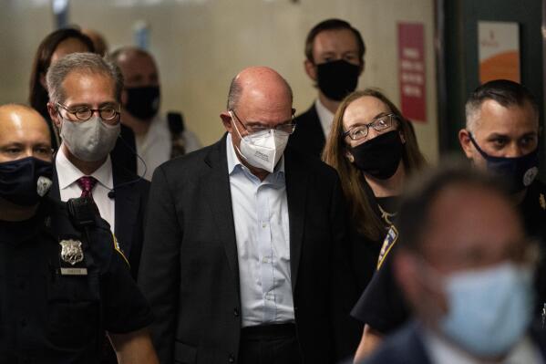 Allen Weisselberg, center, departs Manhattan criminal court, Thursday, July 1, 2021, in New York.  Weisselberg was arraigned a day after a grand jury returned an indictment charging him and Trump’s company with tax crimes. Trump himself was not charged. (AP Photo/John Minchillo)