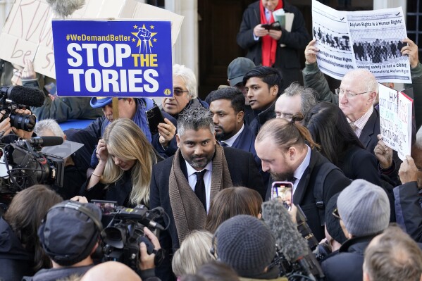 Lawyer Tofique Hossain addresses the media outside the Supreme Court in London, Wednesday, Nov. 15, 2023. Britain's Supreme Court has ruled that the government's contentious plan to send some migrants on a one-way trip to Rwanda is illegal. Five justices on the country's top court said Wednesday that asylum-seekers would be "at real risk of ill-treatment" because they could be sent back to their home countries once they were in Rwanda.The ruling is a major blow to a key government policy that has drawn international attention and criticism.(AP Photo/Alberto Pezzali)