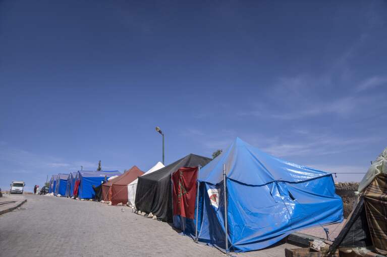 Tents for people displaced by the earthquake line up along a road leading into the town of Amizmiz, outside Marrakech, Morocco, Saturday, Oct. 7, 2023. (AP Photo/Mosa'ab Elshamy)