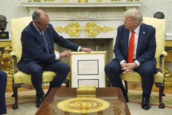 President Donald Trump, right, meets Germany's Chancellor Friedrich Merz in the Oval Office of the White House, Thursday, June 5, 2025, in Washington. (AP Photo/Evan Vucci)