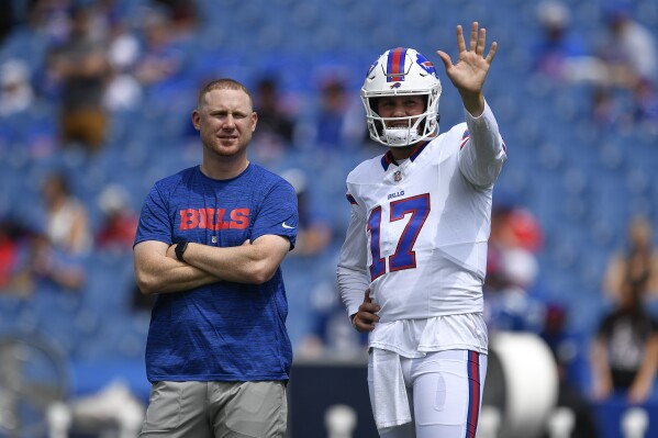 FILE - Buffalo Bills quarterback Josh Allen, right, talks with then-quarterbacks coach Joe Brady before an NFL preseason football game against the Indianapolis Colts in Orchard Park, N.Y., Saturday, Aug. 12, 2023. Bills offensive coordinator Joe Brady has no intention of re-inventing the wheel after having the interim tag removed from his title during an offseason that featured a seismic shift of Buffalo’s lineup of leaders and play-makers.(AP Photo/Adrian Kraus, File)