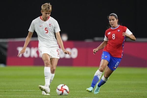 Canada's Quinn, left, and Chile's Karen Araya vie for the ball during a women's soccer match at the 2020 Summer Olympics, Saturday, July 24, 2021, in Sapporo, Japan. (AP Photo/Silvia Izquierdo)