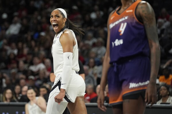 Las Vegas Aces center A'ja Wilson (22) celebrates after scoring against the Phoenix Mercury during the first half of a WNBA basketball game Tuesday, May 14, 2024, in Las Vegas. (AP Photo/John Locher)