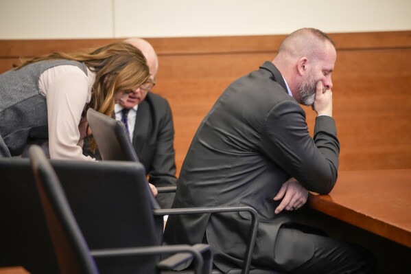 Jason Meade covers his face while waiting for Judge David Young to return to the courtroom in his trial at the Franklin County Common Pleas Court on Friday, Feb. 16, 2024 in Columbus, Ohio. A judge declared a mistrial Friday in the murder trial of the former Ohio sheriff’s deputy because the jury was unable to reach a verdict. Meade was charged with murder and reckless homicide in the December 2020 killing of Casey Goodson Jr. (Brooke LaValley/The Columbus Dispatch via AP, Pool0