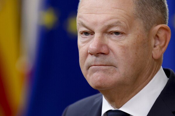Germany's Chancellor Olaf Scholz talks to journalists as he arrives to an EU summit in Brussels, Thursday, Oct. 17, 2024. (AP Photo/Geert Vanden Wijngaert)