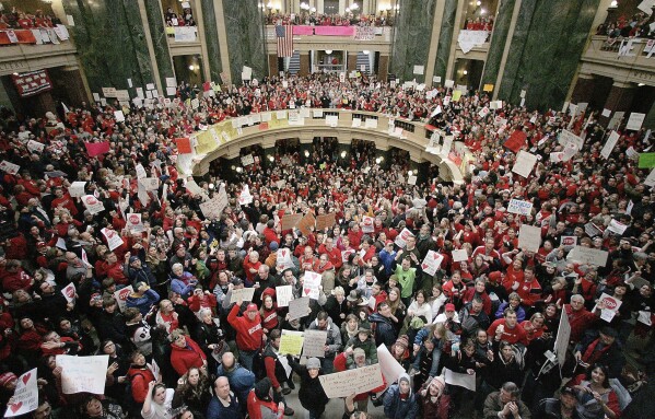 FILE - A crowd fills the Wisconsin Capitol rotunda on the fifth day of labor demonstrations, Feb. 16, 2011, in Madison, Wis. Thousands came to protest the governor's proposal to eliminate collective bargaining for most public workers. Seven unions representing teachers and other public workers in Wisconsin filed a lawsuit Thursday, Nov. 30, 2023, attempting to end the state's near-total ban on collective bargaining for most public employees. (Craig Schreiner/Wisconsin State Journal via AP, File)