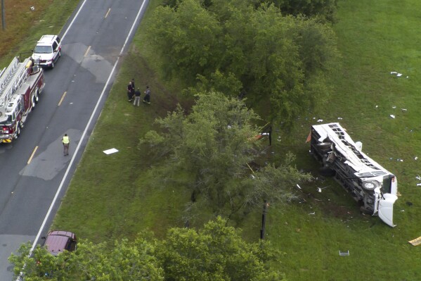 Emergency workers work the scene of a fatal bus crash carrying laborers that overturned Tuesday morning, May 14, 2024, in Ocala, Fla. (Doug Engle/Ocala Star-Banner via AP)