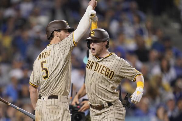 San Diego Padres' Jake Cronenworth, right, celebrates his solo home run with Wil Myers during the eighth inning in Game 2 of the baseball team's NL Division Series against the Los Angeles Dodgers, Wednesday, Oct. 12, 2022, in Los Angeles. (AP Photo/Ashley Landis)