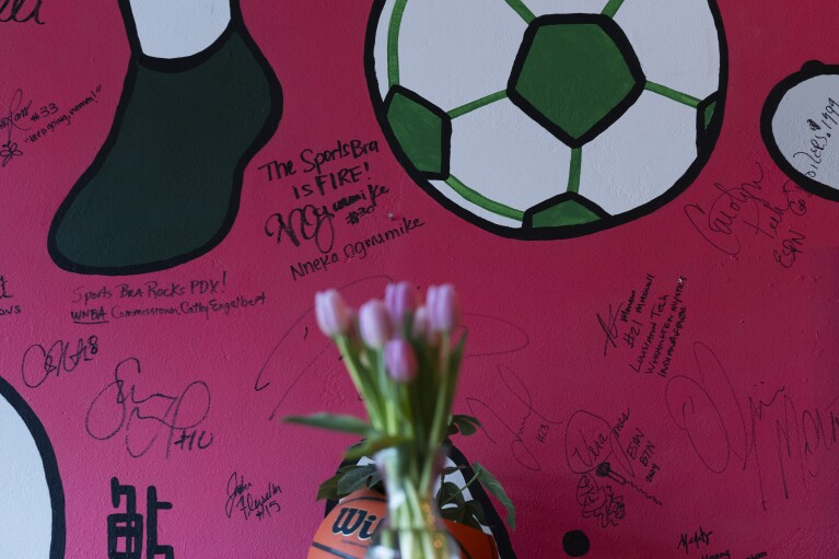 Autographs from WNBA commissioner Cathy Engelbert and professional basketball player Nneka Ogwumike are seen on the wall at The Sports Bra sports bar on Wednesday, April 24, 2024, in Portland, Ore. Ogwumike now plays for the Seattle Storm. (AP Photo/Jenny Kane)