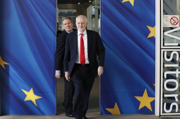 FILE - In this Thursday, March 21, 2019 file photo British Labour Party leader Jeremy Corbyn, right, and Keir Starmer, Labour Shadow Brexit secretary, leave EU headquarters prior to an EU summit in Brussels. (AP Photo/Frank Augstein, File)