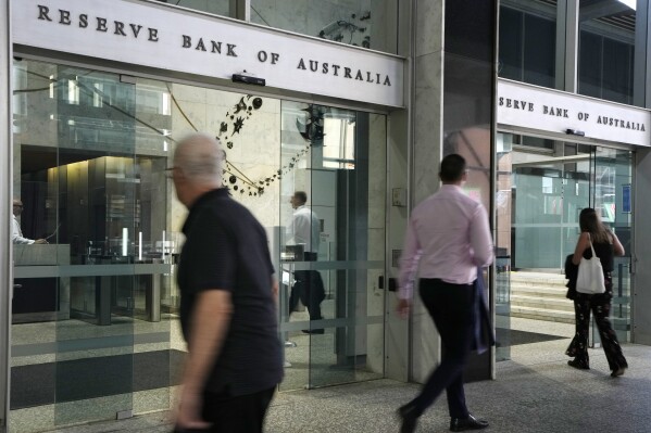 People arrive at the Reserve Bank of Australia in Sydney, Dec. 6, 2022. (AP Photo/Rick Rycroft, File)