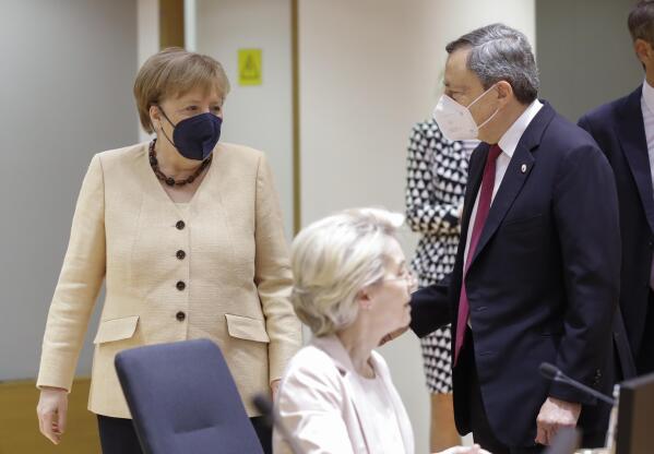 German Chancellor Angela Merkel, left, talks to Italian Prime Minister Mario Draghi during an EU summit at the European Council building in Brussels, Friday, June 25, 2021. During the second of two days summit EU leaders are discussing the economic challenges the bloc faces due to coronavirus restrictions and will review progress on their banking union and capital markets union. (Olivier Hoslet, Pool Photo via AP)