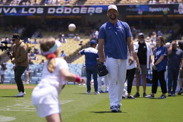 Los Angeles Dodgers starting pitcher Clayton Kershaw, right, plays ball with his daughter before a baseball game against the San Diego Padres, Sunday, May 14, 2023, in Los Angeles. (AP Photo/Allison Dinner)