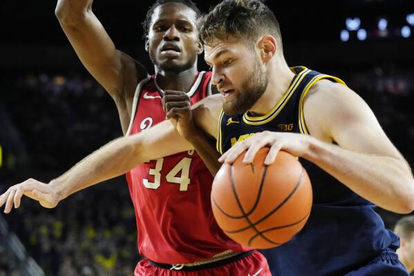 Michigan center Hunter Dickinson (1) drives on Ohio State center Felix Okpara (34) during the second half of an NCAA college basketball game, Sunday, Feb. 5, 2023, in Ann Arbor, Mich. (AP Photo/Carlos Osorio)