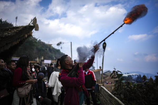 A man shoots a local handmade gun during the Hornbill Festival in Kisama, on the outskirts of Kohima, capital of the northeastern Indian state of Nagaland, Tuesday, Dec. 10, 2024. (AP Photo/Anupam Nath)