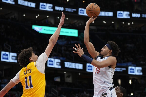 Washington Wizards guard Jordan Poole (13) goes up to shoot against Los Angeles Lakers center Jaxson Hayes (11) during the first half of an NBA basketball game Thursday, Jan. 30, 2025, in Washington. (AP Photo/Jess Rapfogel)