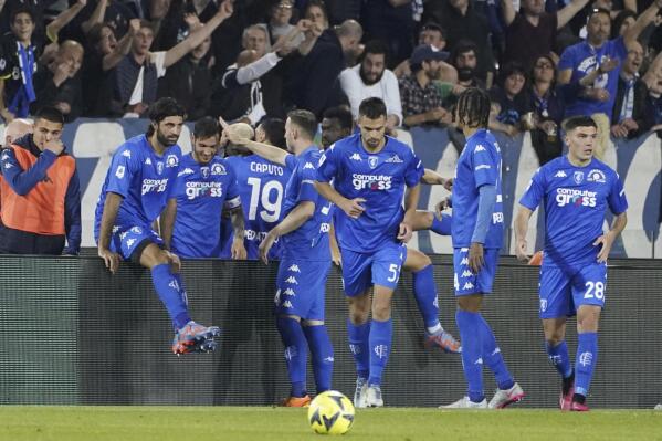 Empoli players celebrate their side's third goal of the game during the Serie A soccer match between Empoli and Juventus, at the Carlo Castellani stadium in Empoli, Italy, Monday, May 22, 2023. (Marco Bucco/LaPresse via AP)