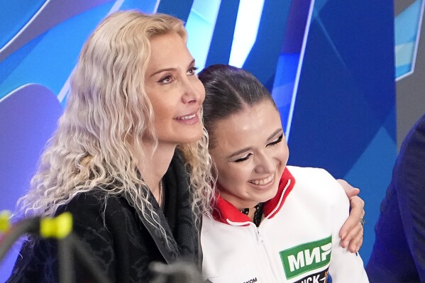 FILE -Russian Kamila Valieva, center, and her coach Eteri Tutberidze, left, react after competing in the women's free skate program during the figure skating competition at the 2023 Russian Figure Skating Grand Prix in Moscow, Russia, Sunday, Nov. 26, 2023. Russian figure skater Kamila Valieva has been disqualified from the 2022 Beijing Olympics. The verdict from the Court of Arbitration for Sport comes almost two years after Valieva's doping case caused turmoil at the Beijing Games. (AP Photo/Alexander Zemlianichenko, File)
