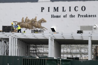FILE - A crew works on putting up a platform near the main entrance at Pimlico Race Course, May 15, 2020, in Baltimore. Maryland lawmakers approved a plan to rebuild Baltimore’s storied but antiquated race course and transfer the track to state control in the waning hours of the state's legislative session on Monday, April 8, 2024. (AP Photo/Julio Cortez, File)