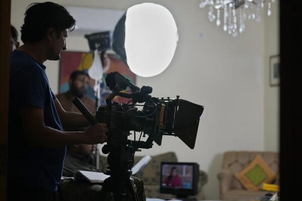 A cameraman films on the set during the during the shooting of a scene of tv drama serial 