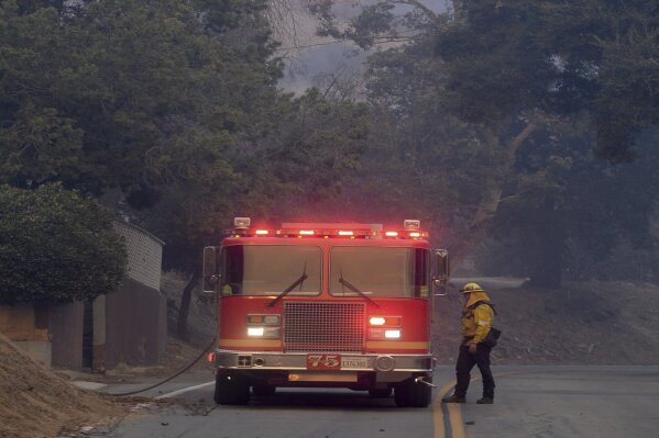 
              Flames ignite in trees above Kagel Canyon as firefighters set up for structure protection at the Creek fire Tuesday, Dec. 5, 2017 in Lake View Terrace area of Los Angeles .  Raked by ferocious Santa Ana winds, explosive wildfires northwest of Los Angeles and in the city's foothills burned a psychiatric hospital and scores of other structures Tuesday and forced the evacuation of tens of thousands of people.   (David Crane/Los Angeles Daily News via AP)
            