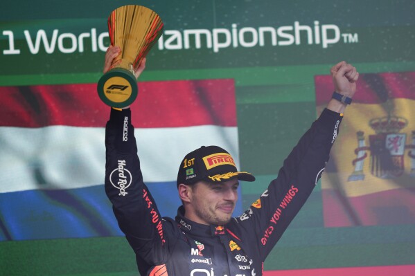 Red Bull driver Max Verstappen of the Netherlands celebrates at the podium after winning the Brazilian Formula One Grand Prix at the Interlagos race track in Sao Paulo, Brazil, Sunday, Nov. 5, 2023. (AP Photo/Andre Penner)