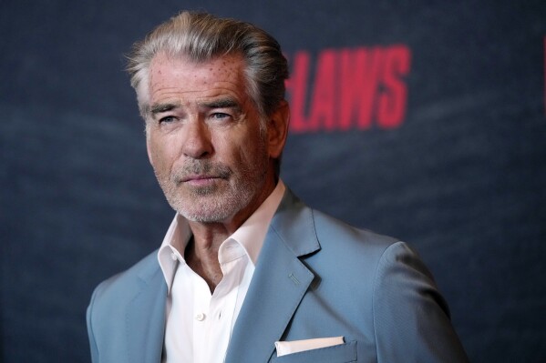 FILE - Pierce Brosnan, a cast member in "The Out-Laws," poses at a special screening of the film, June 26, 2023, at the Regal LA Live theaters in Los Angeles. Brosnan, whose fictitious movie character James Bond has been in hot water plenty of times, pleaded guilty Thursday, March 14, 2024, to stepping out of bounds in a thermal area during a November 2023 visit to Yellowstone National Park. (AP Photo/Chris Pizzello, File)