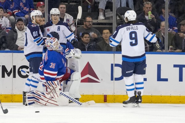 New York Rangers goaltender Igor Shesterkin (31) reacts as Winnipeg Jets center Mark Scheifele (55) celebrates after scoring with left wing Kyle Connor (81) and left wing Alex Iafallo (9) during the second period of an NHL hockey game, Tuesday, March 19, 2024, at Madison Square Garden in New York. (AP Photo/Mary Altaffer)
