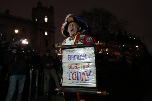 A Brexit supporter shouts during a rally in London, Friday, Jan. 31, 2020. Britain officially leaves the European Union on Friday after a debilitating political period that has bitterly divided the nation since the 2016 Brexit referendum. (AP Photo/Frank Augstein)