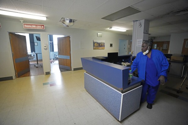 Alliance Healthcare System hospital Environmental Service Manager Ardency Baird checks on empty hospital beds in one of the shut-down floors of the Holly Springs, Miss., facility Feb. 29, 2024. One of the requirements to be approved as a rural emergency hospital is the closing of all inpatient beds and providing 24/7 emergency care. (AP Photo/Rogelio V. Solis)