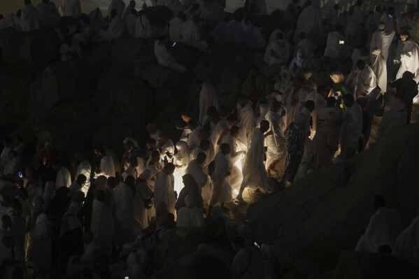 Muslim pilgrims arrive at the rocky hill known as the Mountain of Mercy on the Plain of Arafat during the annual Hajj pilgrimage near the holy city of Mecca, Saudi Arabia, Thursday, June 5, 2025. (AP Photo/Amr Nabil)