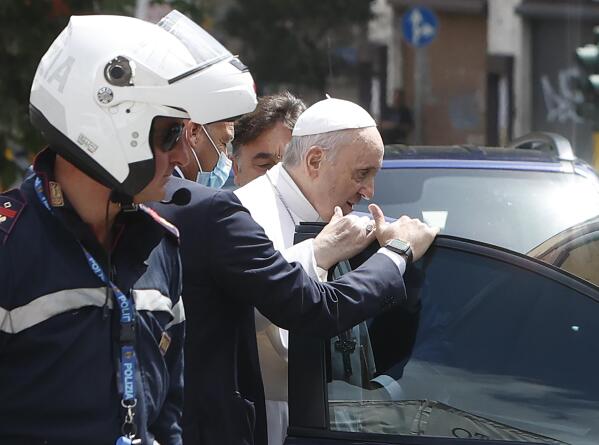 Pope Francis stops to greet police that escorted him as he arrives at the Vatican after leaving the hospital on his Ford, 10 days after undergoing planned surgery to remove half his colon Wednesday, July 14, 2021. Francis had half of his colon removed for a severe narrowing of his large intestine on July 4, his first major surgery since he became pope in 2013. (AP Photo/Riccardo De Luca)