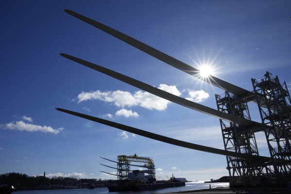 A generator and its blades, bottom, are tugged at sea leaving State Pier in New London, Conn., Monday, Dec. 4, 2023, heading to South Fork Wind farm. (APPhoto/Seth Wenig)