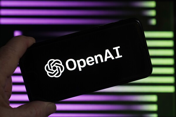 FILE - The logo for OpenAI, the maker of ChatGPT, appears on a mobile phone, in New York, Jan. 31, 2023. Lawmakers in Brazil鈥檚 southern city of Porto Alegre Brazil have enacted legislation written entirely by artificial intelligence. The experimental ordinance was passed in October and city councilman Ramiro Ros谩rio revealed on Thursday, Nov. 29, 2023, that it was written by a chatbot, sparking objections and raising questions about the role of artificial intelligence in public policy. (AP Photo/Richard Drew, File)