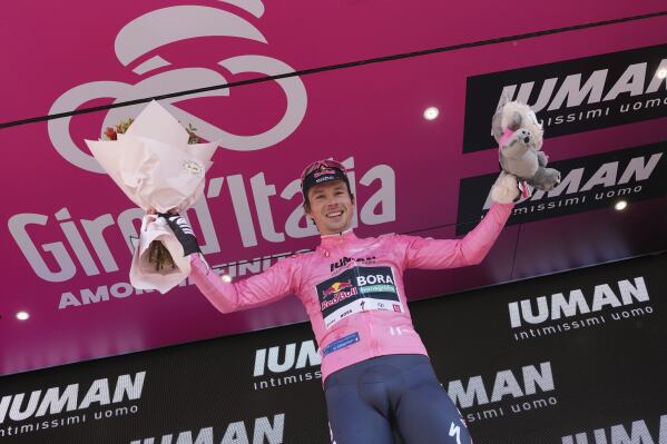 Slovenia's Primoz Roglic celebrates on the podium after earning the pink jersey of overall leader after the time trial stage 2 of the Giro d'Italia cycling race, in Tirana, Albania, Saturday, May 10, 2025. (Gian Mattia D'Alberto/LaPresse via AP)