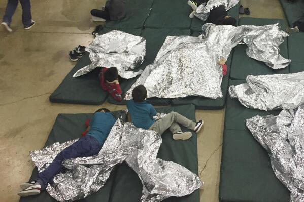 FILE - In this photo provided by U.S. Customs and Border Protection, people who've been taken into custody related to cases of illegal entry into the U.S. rest in one of the cages at a facility in McAllen, Texas, on June 17, 2018. The 9th Circuit Court of Appeals issued a ruling Monday, May 22, 2023, reversing a Nevada federal judge’s unprecedented decision more than two years ago that struck down a felony deportation law as unconstitutional and discriminatory against Latinos. (U.S. Customs and Border Protection's Rio Grande Valley Sector via AP, File)