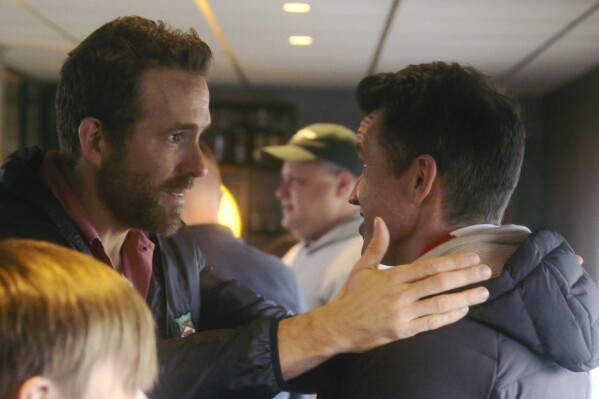 This image released by FX shows Ryan Reynolds, left, and Rob McElhenney in a scene from the third season of "Welcome to Wrexham." (FX via AP)