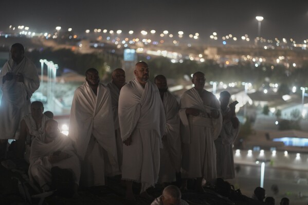 Muslim pilgrims pray on the rocky hill known as the Mountain of Mercy on the Plain of Arafat during the annual Hajj pilgrimage near the holy city of Mecca, Saudi Arabia, Thursday, June 5, 2025. (AP Photo/Amr Nabil)