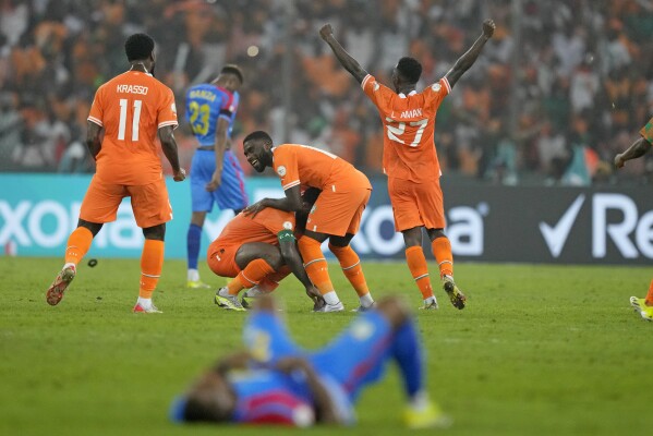 Ivory Coast players, top center, celebrate after winning the African Cup of Nations semifinal soccer match between Ivory Coast and DR Congo, at the Olympic Stadium of Ebimpe in Abidjan, Ivory Coast, Wednesday, Feb. 7, 2024. Ivory Coast won the match 1-0. (APPhoto/Sunday Alamba)