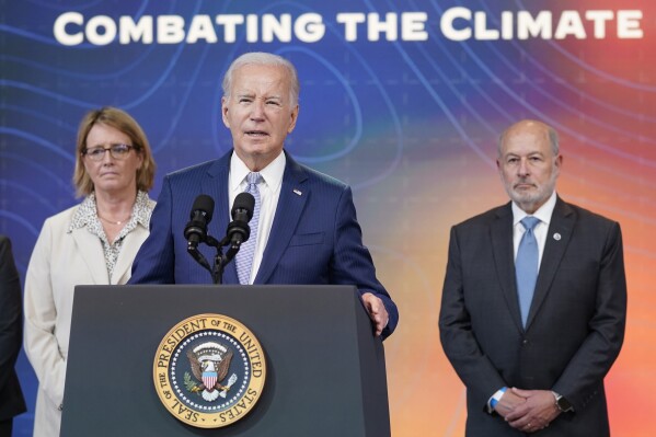 President Joe Biden speaks during an event to announce new measures aimed at helping communities deal with extreme weather, in the South Court Auditorium on the White House Campus, Thursday, July 27, 2023, in Washington. From left, Federal Emergency Management Agency administrator Deanne Criswell, Biden and Rick Spinrad, Administrator of the National Oceanic and Atmospheric Administration. (AP Photo/Evan Vucci)