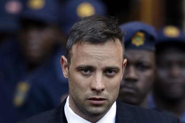 FILE - Oscar Pistorius leaves the High Court in Pretoria, South Africa, Wednesday, June 15, 2016, after his sentencing proceedings. Pistorius could be granted parole on Friday, Nov. 24, 2023 after nearly 10 years in prison for killing his girlfriend. The double-amputee Olympic runner was convicted of a charge comparable to third-degree murder for shooting Reeva Steenkamp in his home in 2013. He has been in prison since late 2014. (AP Photo/Themba Hadebe, File)