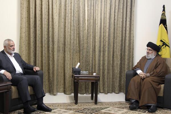 This picture released by the Hezbollah Media Relations Office, shows Hezbollah leader Sayyed Hassan Nasrallah, right, meeting with Ismail Haniyeh, the leader of the Palestinian militant group Hamas, in Beirut, Lebanon, Tuesday, June 29, 2021. (Hezbollah Media Relations Office, via AP )